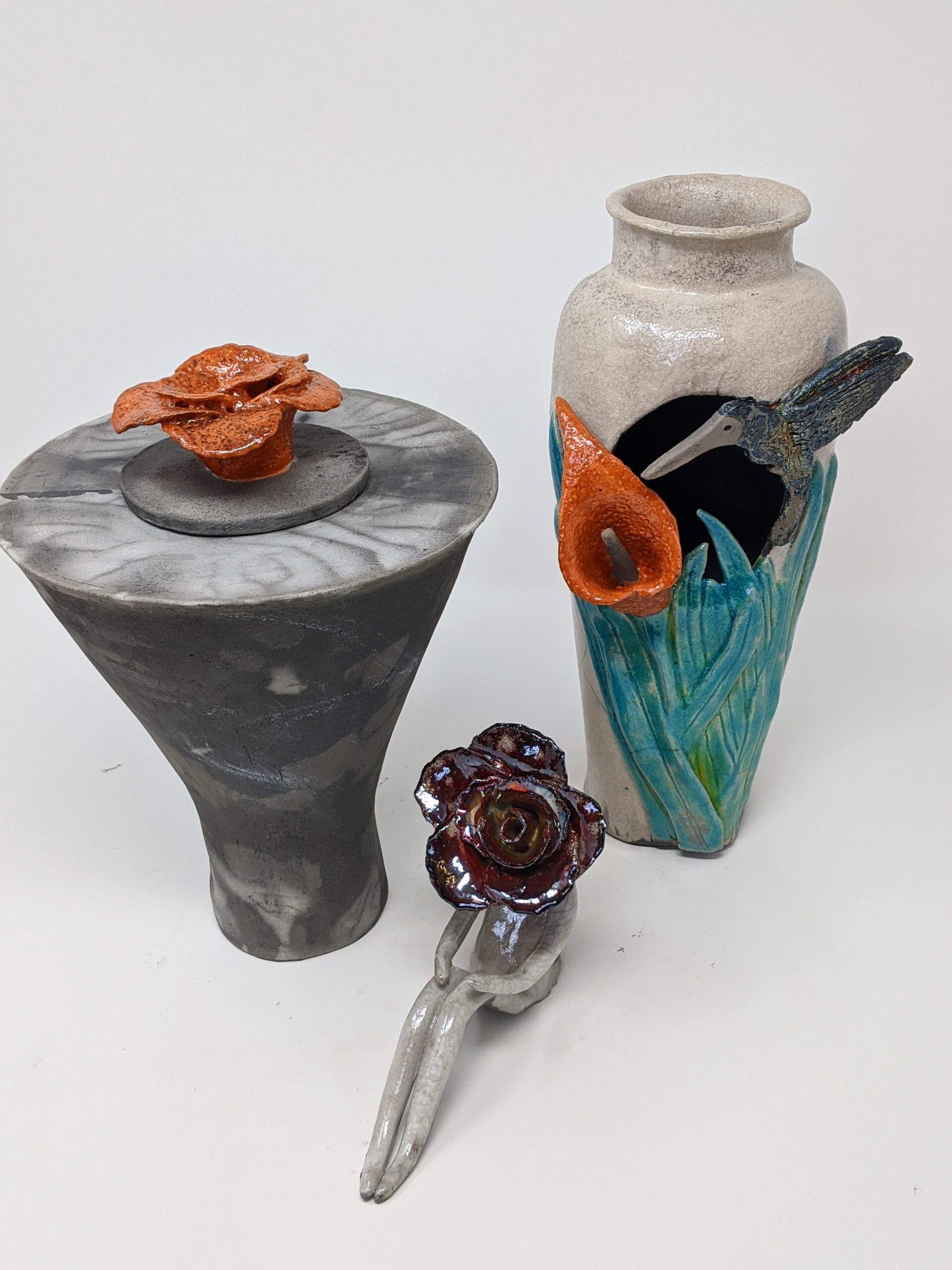 Raku Pottery by Nancy Wojtak Footed bowl with blue glaze drips on a white background creating a unique effect.